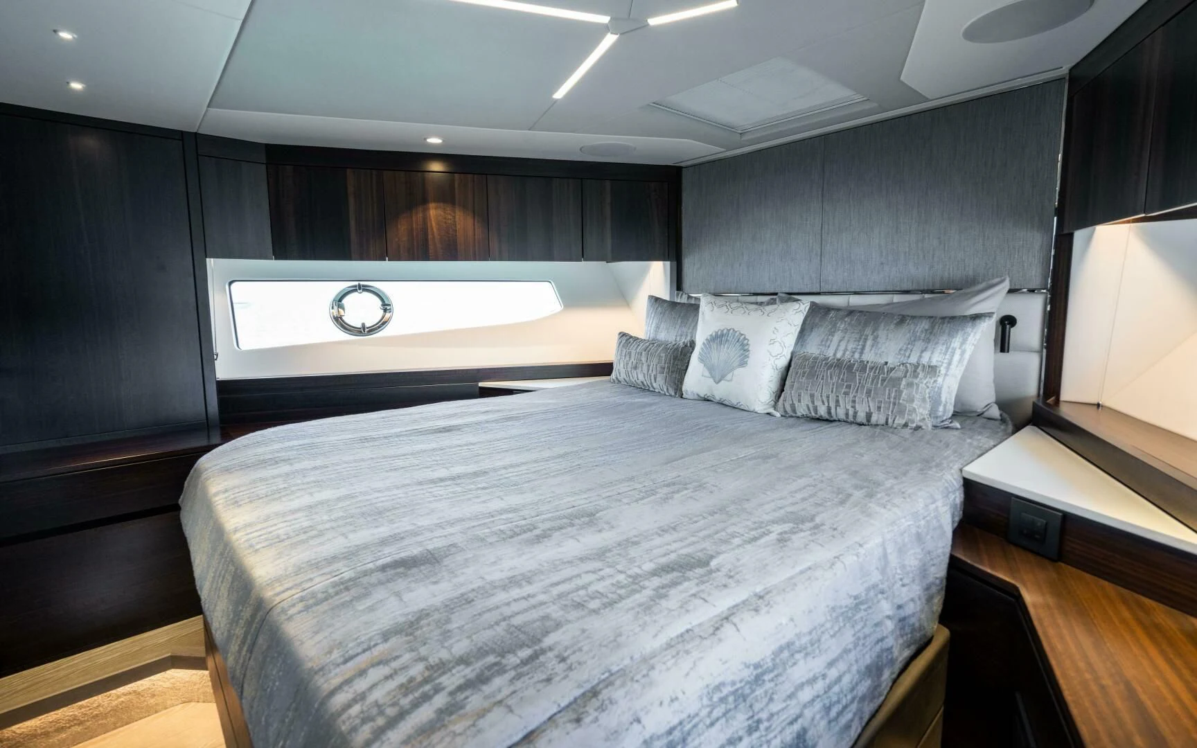a bed with a white comforter aboard 4-PLAY VII Yacht for Sale