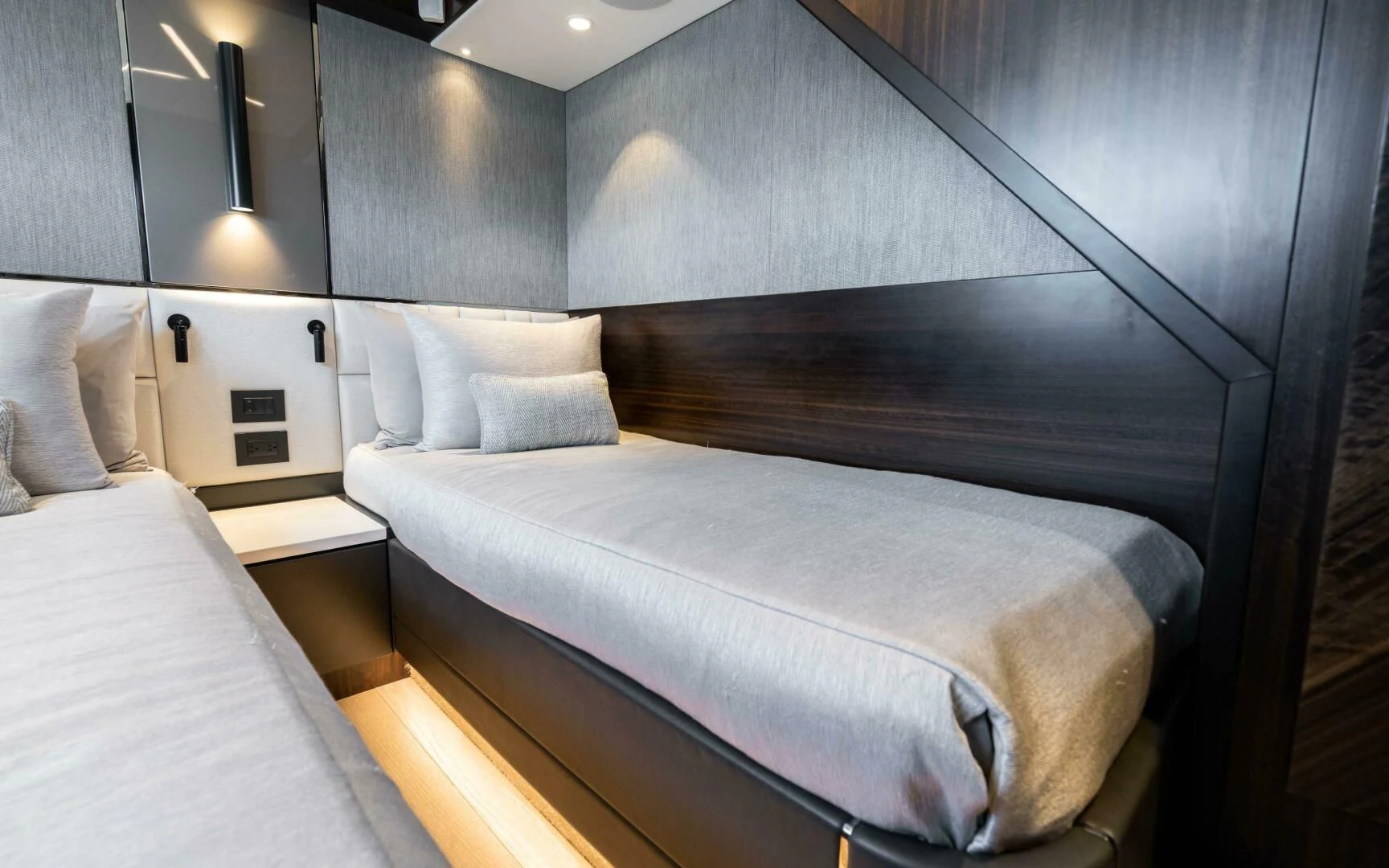 a bed with a black headboard aboard 4-PLAY VII Yacht for Sale