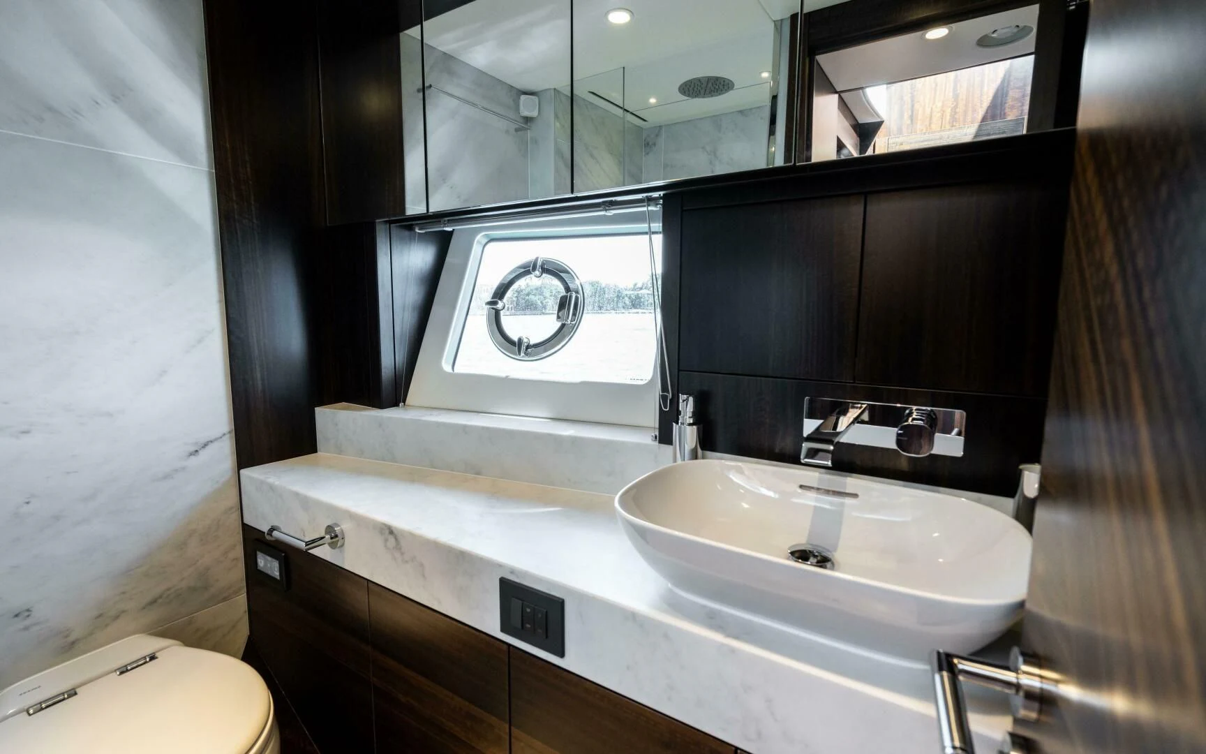 a bathroom with a sink and a mirror aboard 4-PLAY VII Yacht for Sale