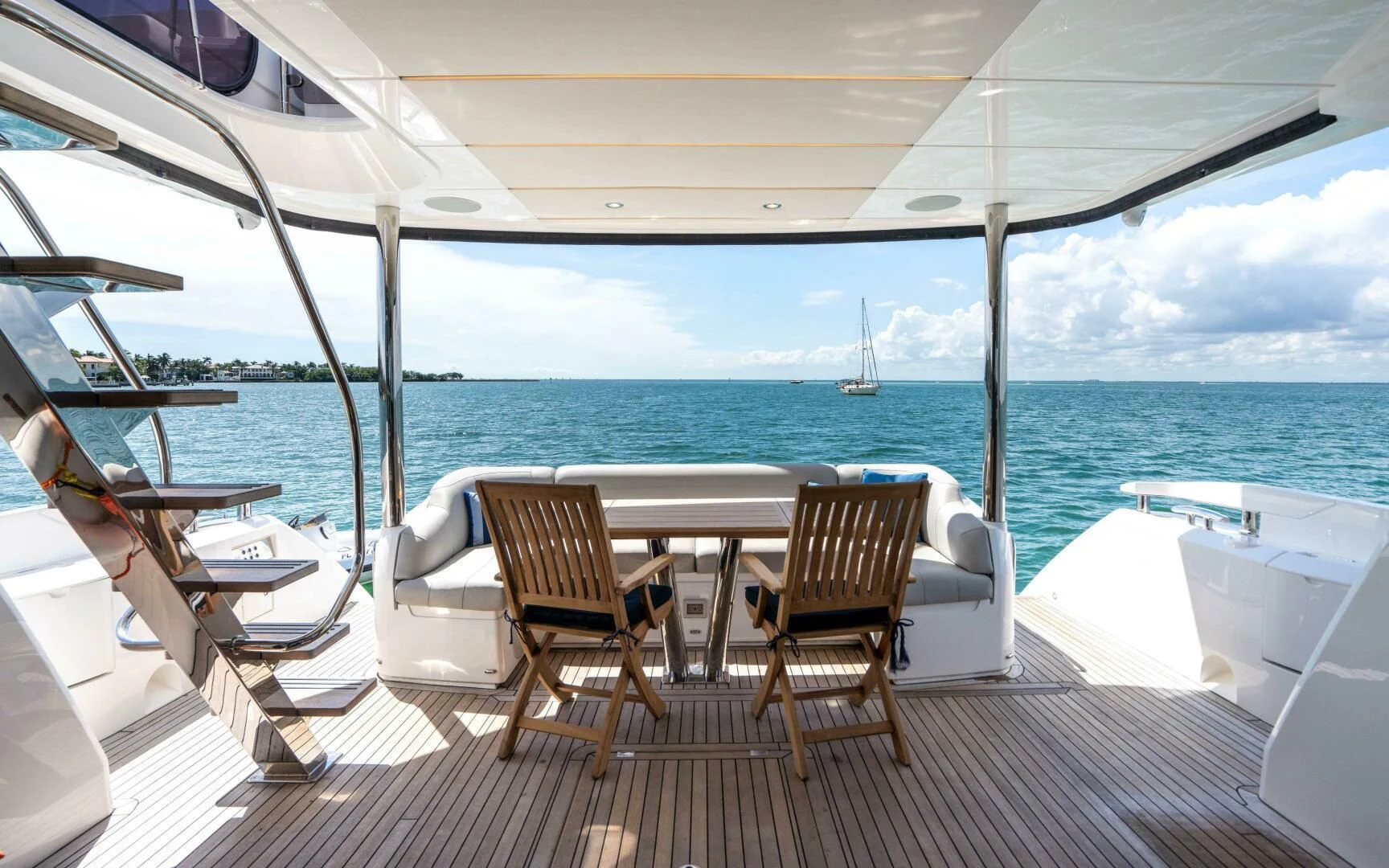 a deck with chairs and tables on it by the water aboard 4-PLAY VII Yacht for Sale