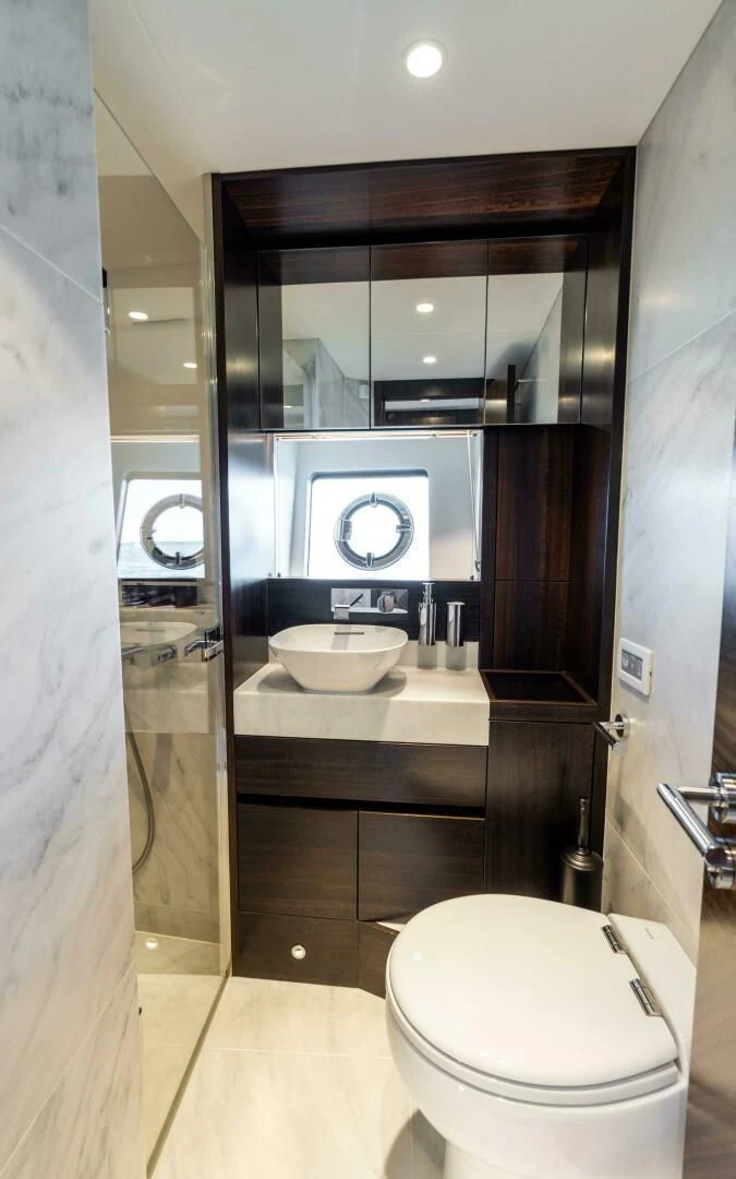 a bathroom with a sink and a toilet aboard 4-PLAY VII Yacht for Sale