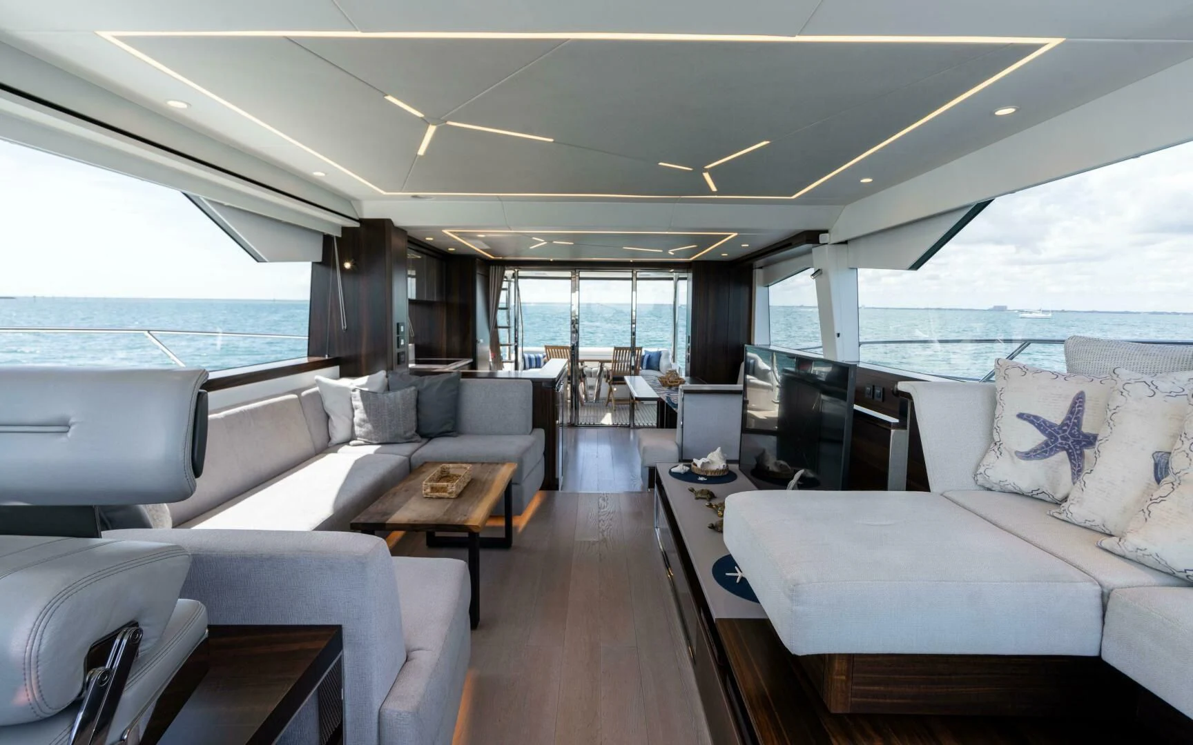 a living room with a couch and a table aboard 4-PLAY VII Yacht for Sale
