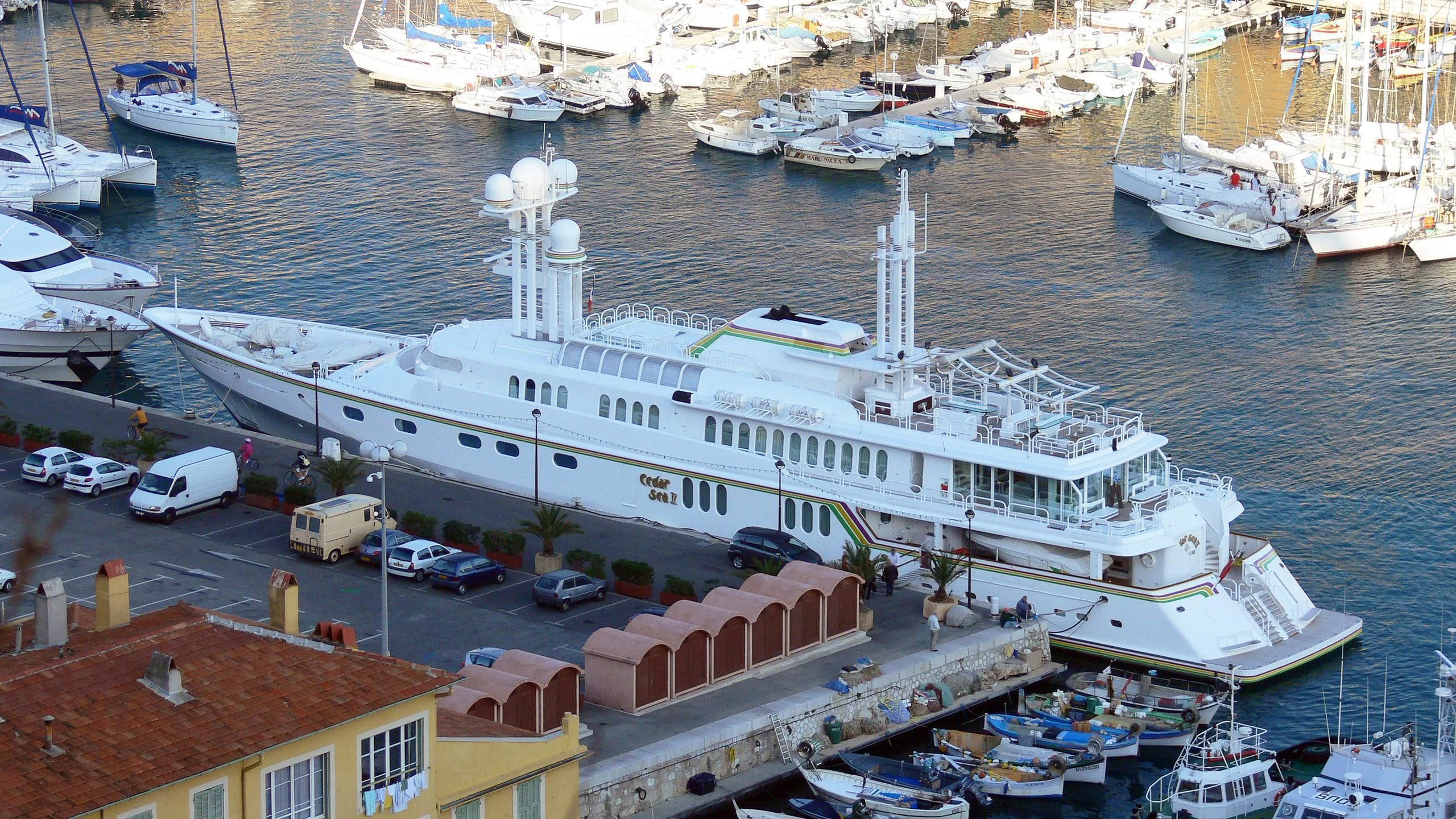 a large ship docked at a harbor aboard CEDAR SEA II Yacht for Sale