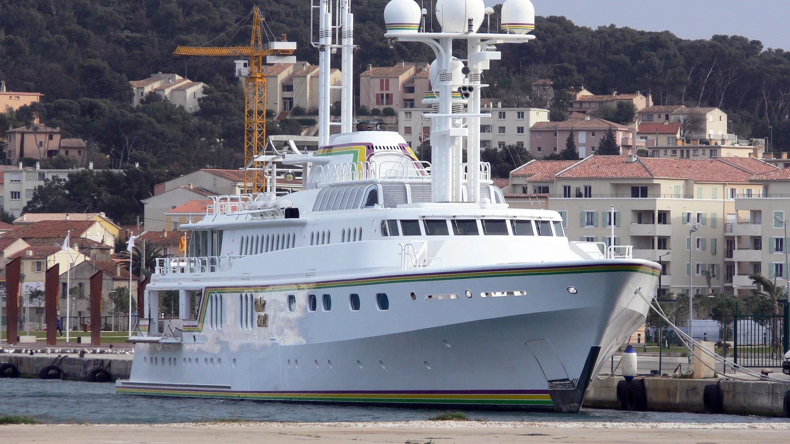a large white boat in a harbor aboard CEDAR SEA II Yacht for Sale