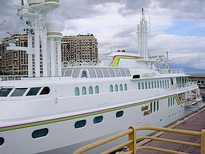 a white boat in a harbor aboard CEDAR SEA II Yacht for Sale