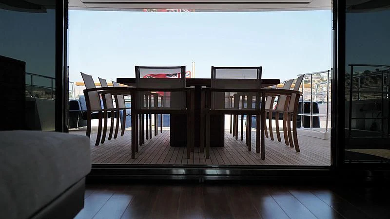 a wood table and chairs on a deck aboard THIRTY EIGHT Yacht for Sale