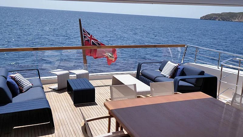a deck with chairs and a table on it aboard THIRTY EIGHT Yacht for Sale