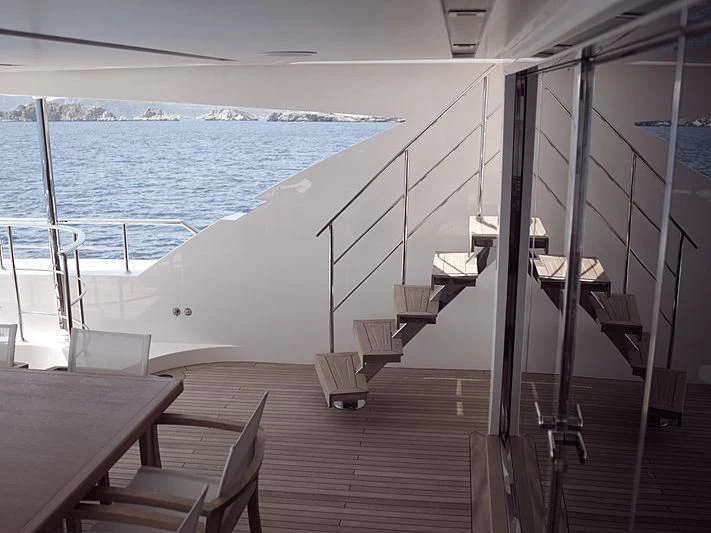 a deck with a large body of water and a large boat in the background aboard THIRTY EIGHT Yacht for Sale