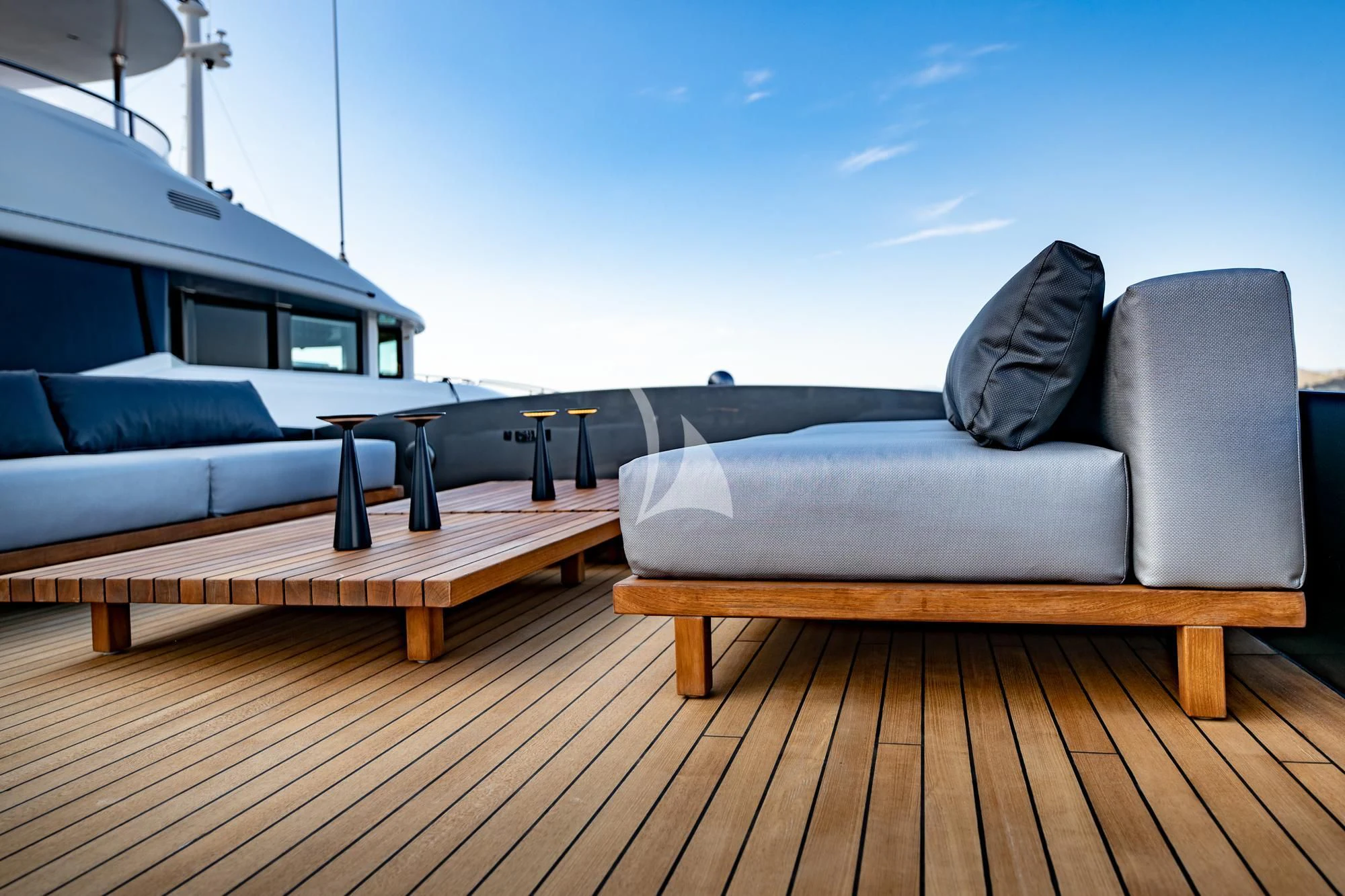 a deck with a couch and a table on it aboard EVA Yacht for Charter