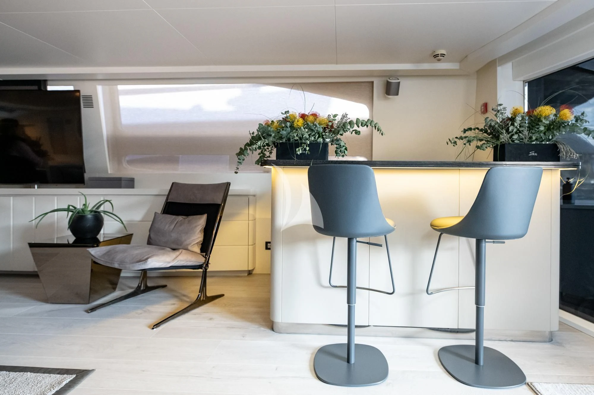 a room with chairs and a table aboard EVA Yacht for Charter