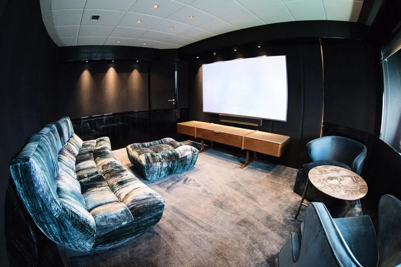 a room with a television and couches aboard EVA Yacht for Charter