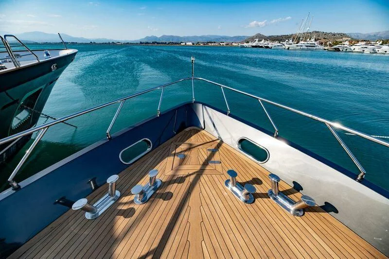 a deck with a boat and chairs on it aboard EVA Yacht for Charter