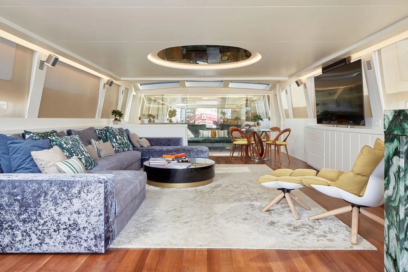 a living room with a couch and a television aboard EVA Yacht for Charter