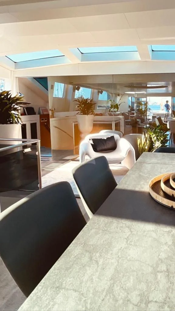 a room with a couch and chairs aboard EVA Yacht for Charter