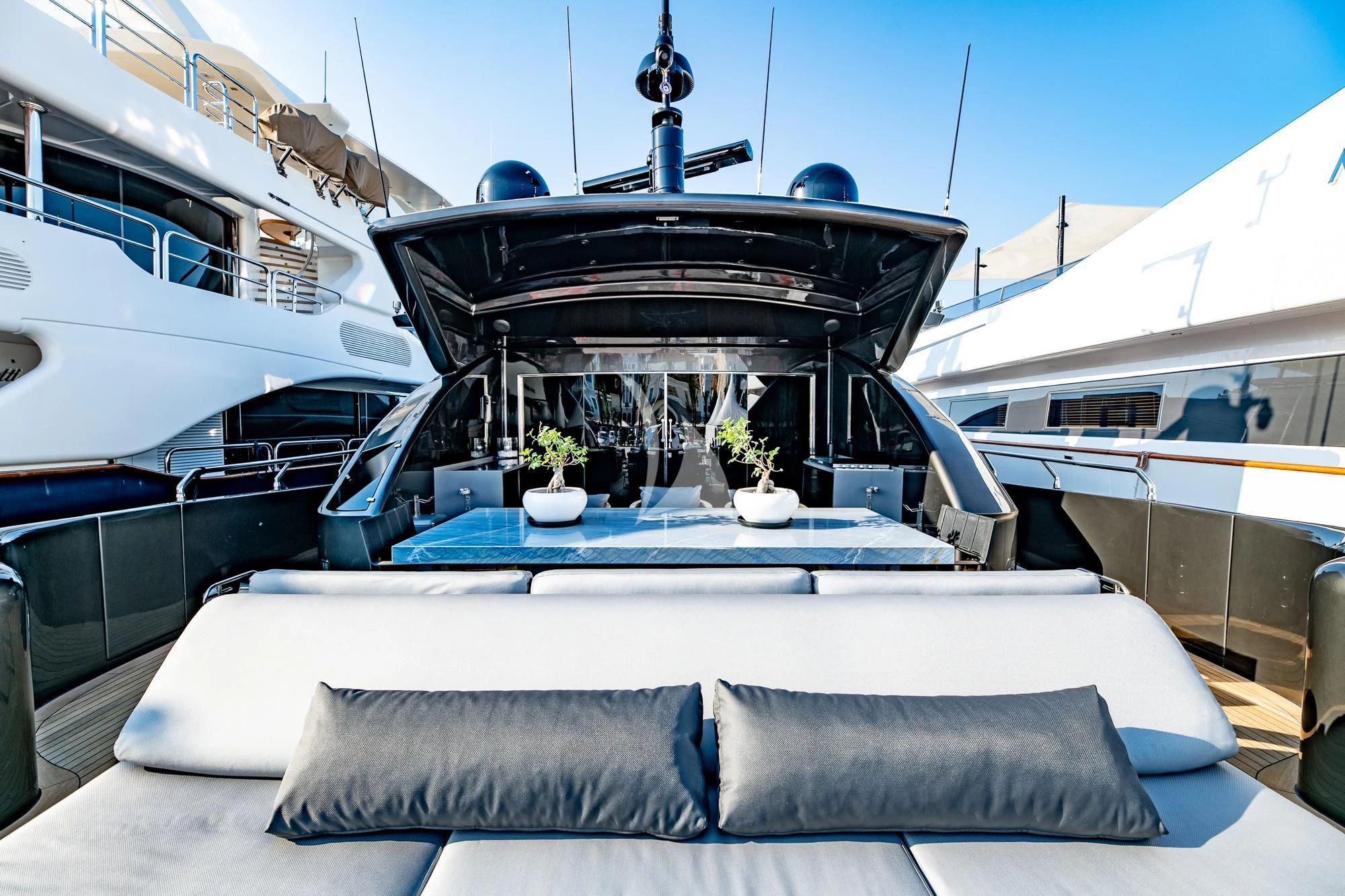 a large white boat with a round glass top and a white couch with a white wall and a aboard EVA Yacht for Charter
