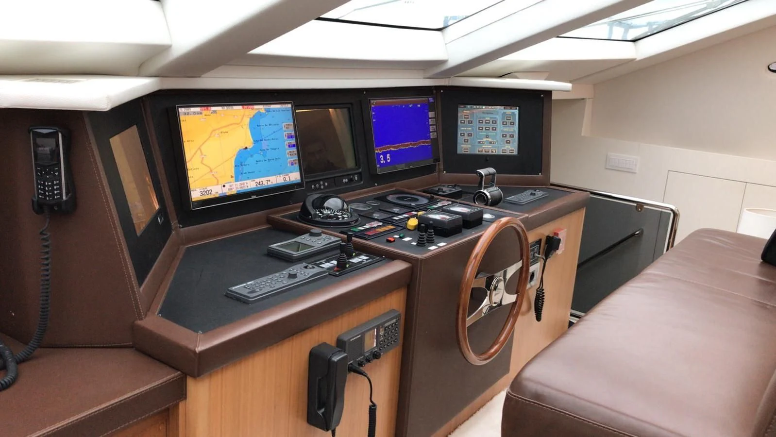 a desk with several monitors and keyboards aboard EVA Yacht for Charter