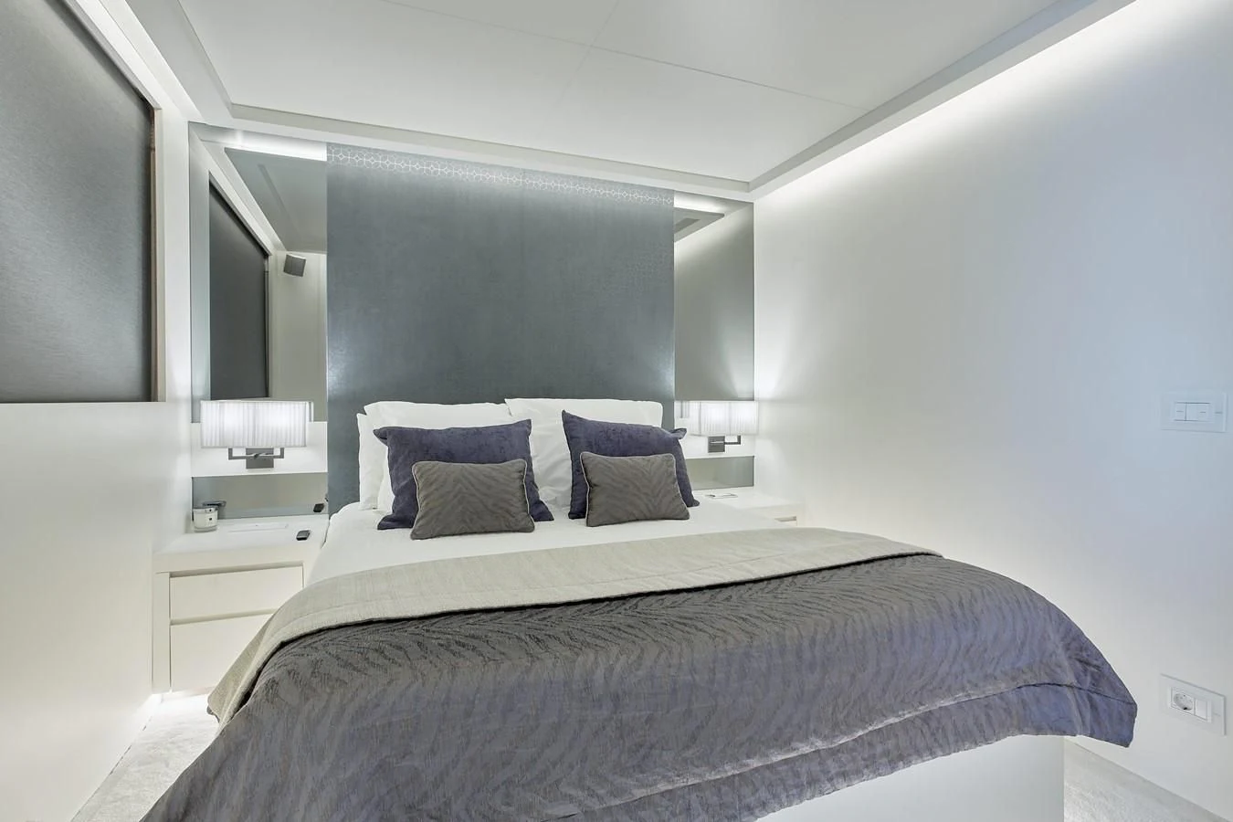 a bedroom with a bed and a desk aboard EVA Yacht for Charter