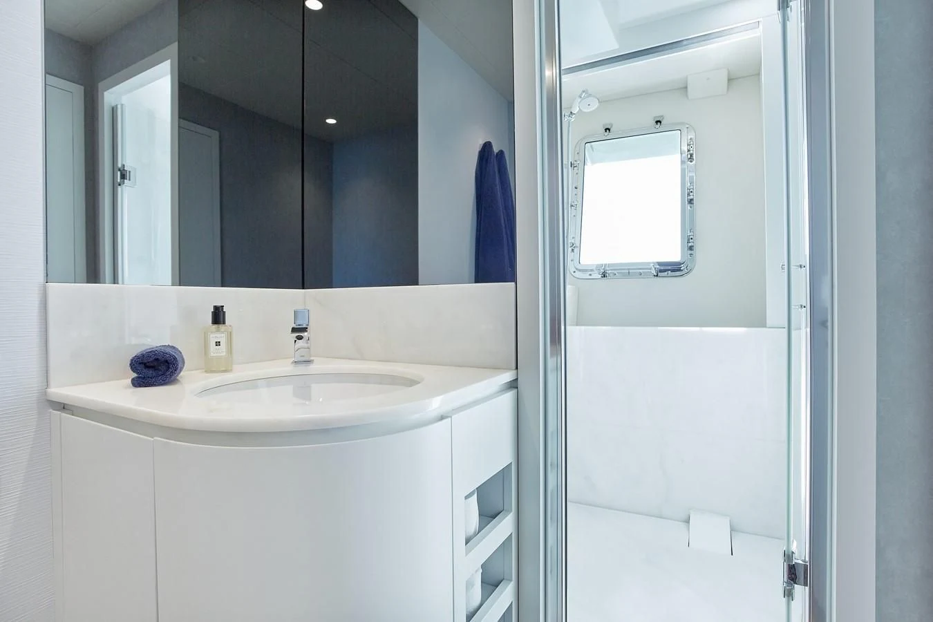 a bathroom with a sink and a mirror aboard EVA Yacht for Charter