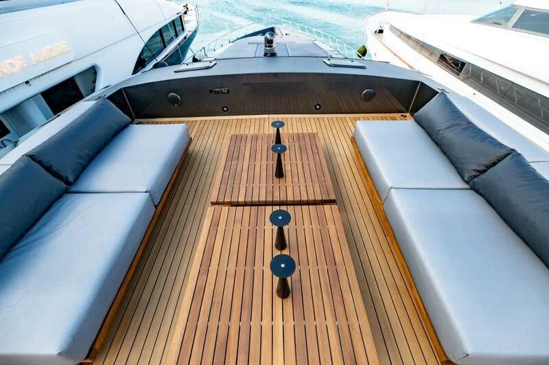 a wooden deck with a boat in the background aboard EVA Yacht for Charter