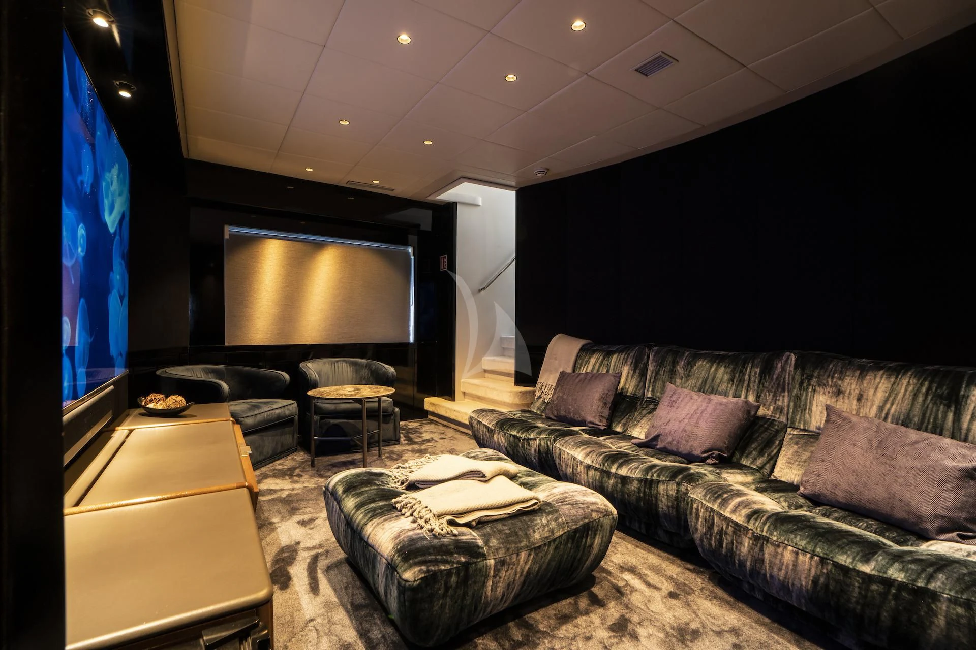 a living room with a couch and a tv aboard EVA Yacht for Charter