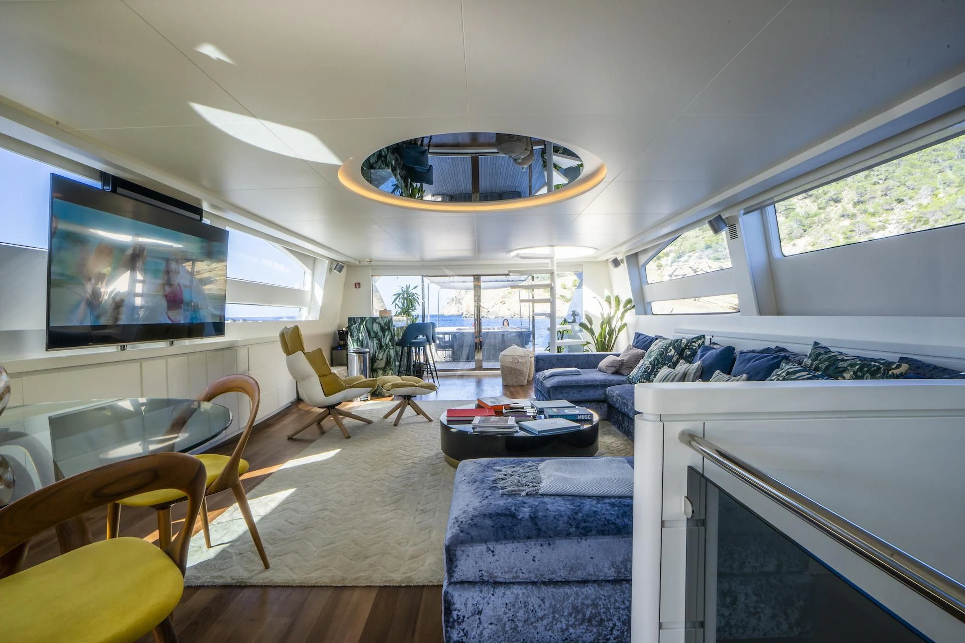 a living room with a large tv aboard EVA Yacht for Charter