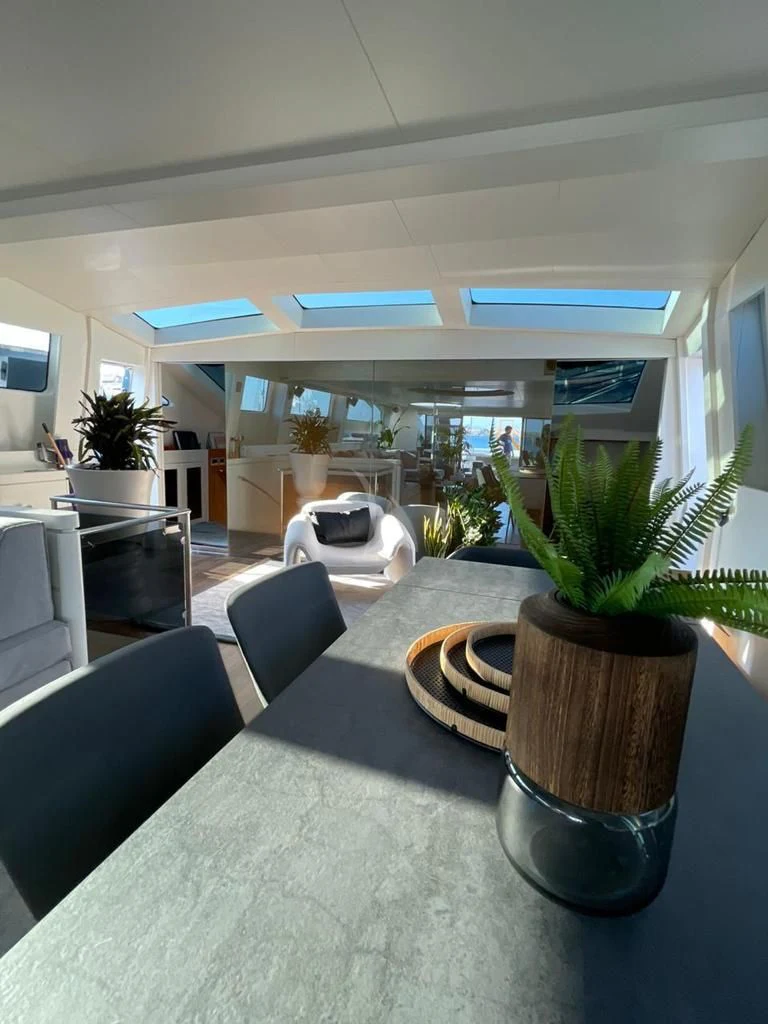 a room with a table and chairs aboard EVA Yacht for Charter