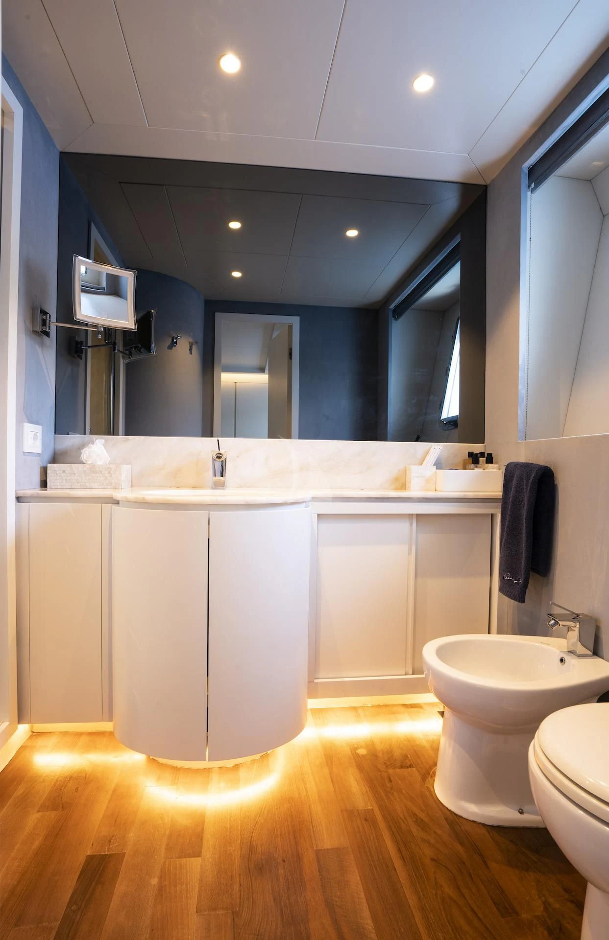 a bathroom with a large mirror aboard EVA Yacht for Charter