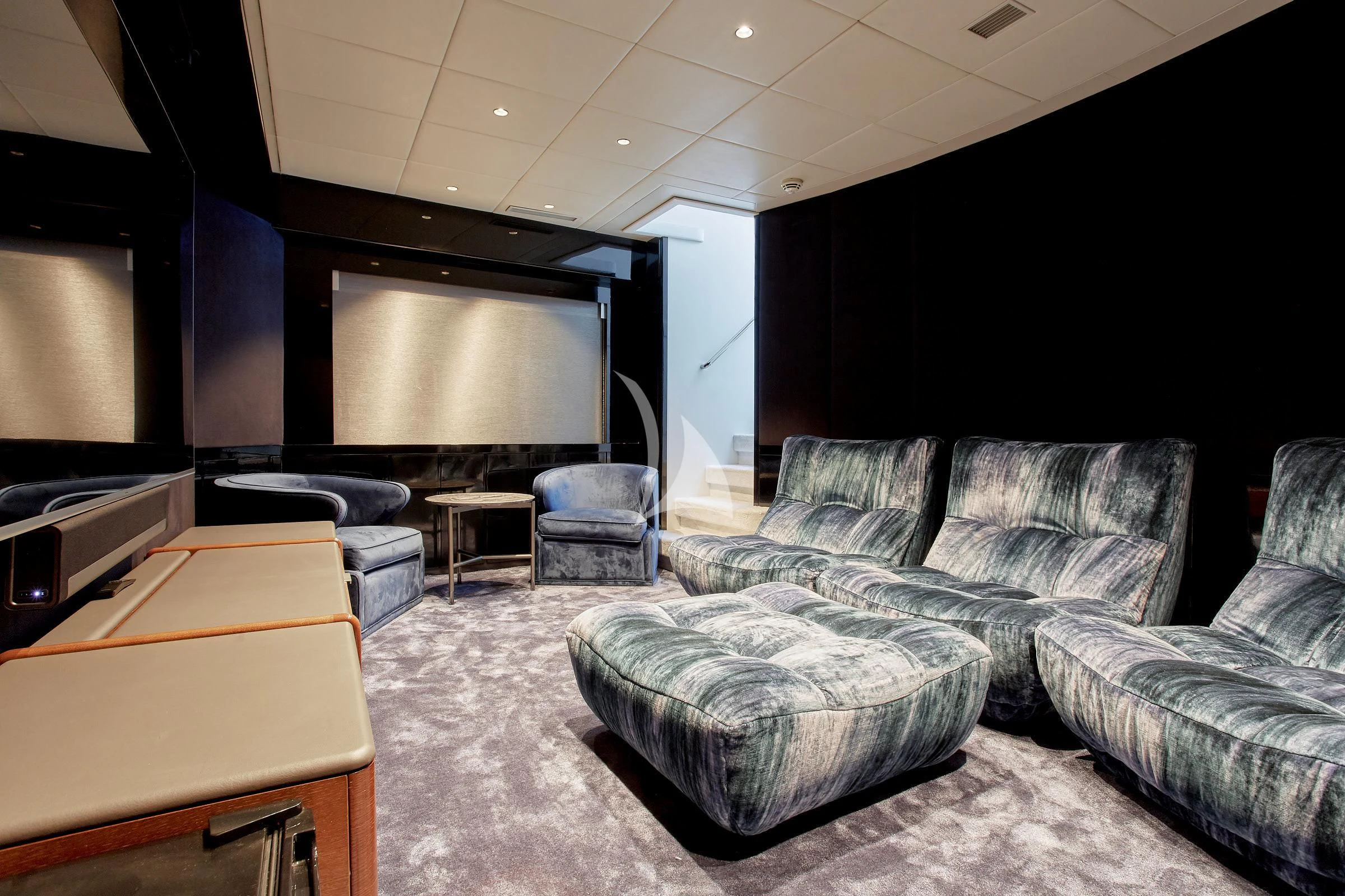 a living room with a large screen aboard EVA Yacht for Charter