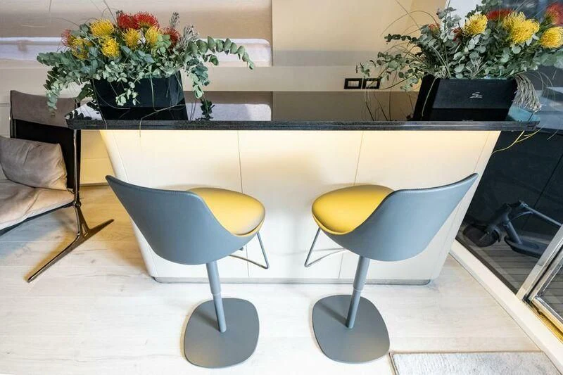 a table with chairs and plants aboard EVA Yacht for Charter