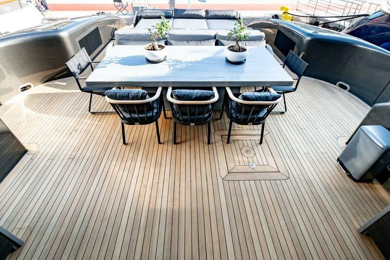 a large table with chairs around it aboard EVA Yacht for Charter