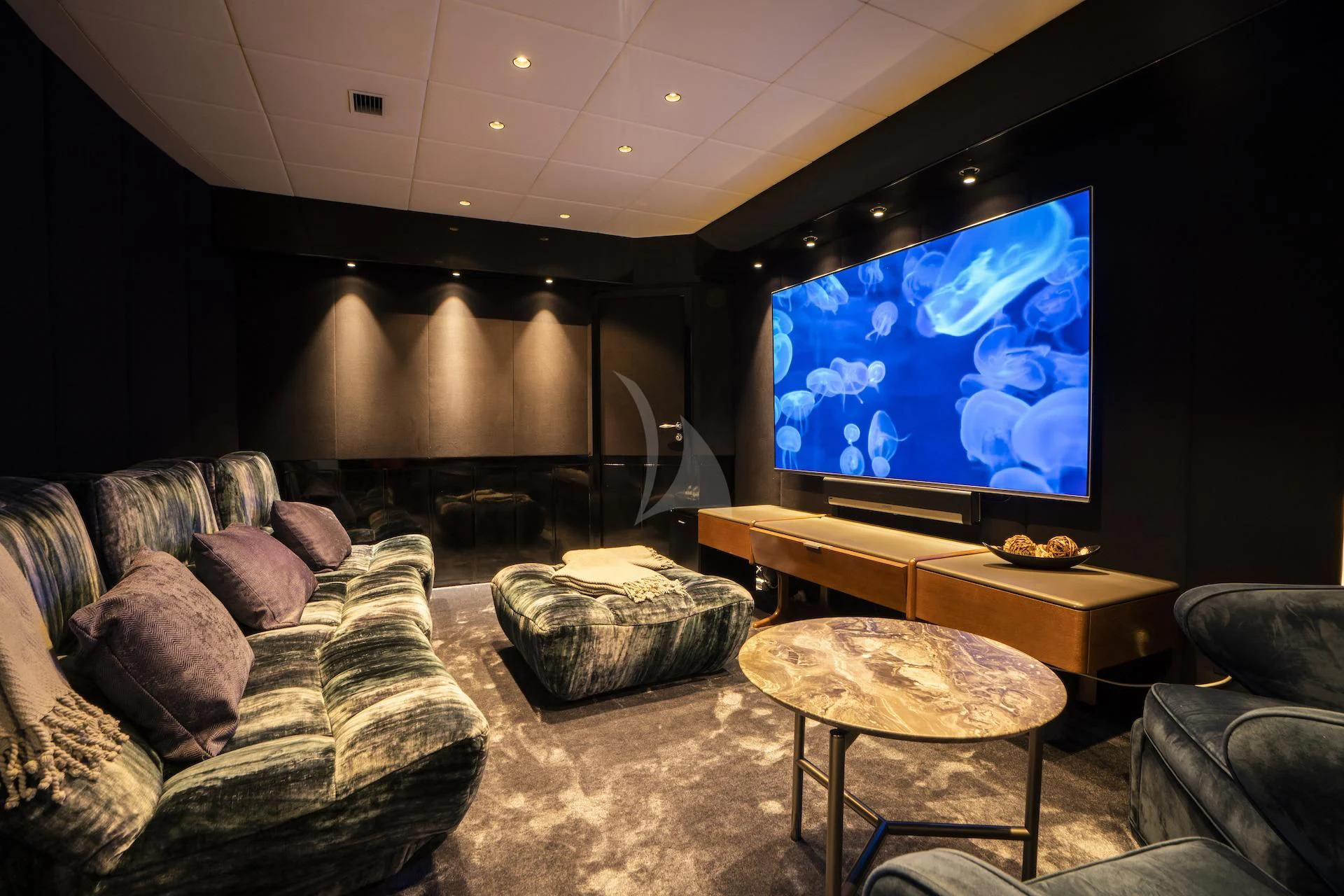a living room with a large television aboard EVA Yacht for Charter