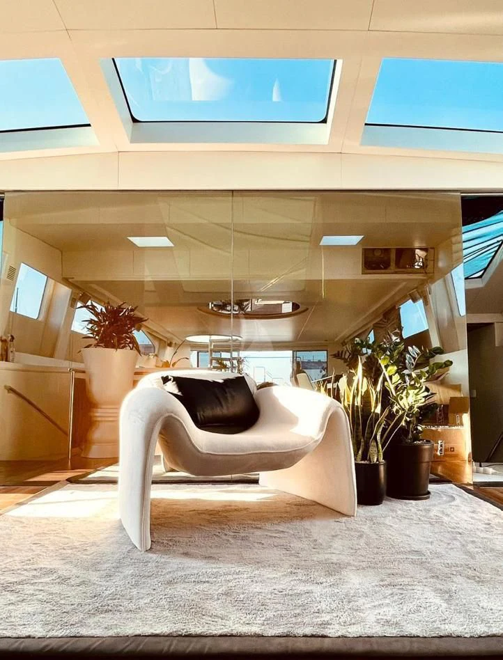 a white couch in a room aboard EVA Yacht for Charter