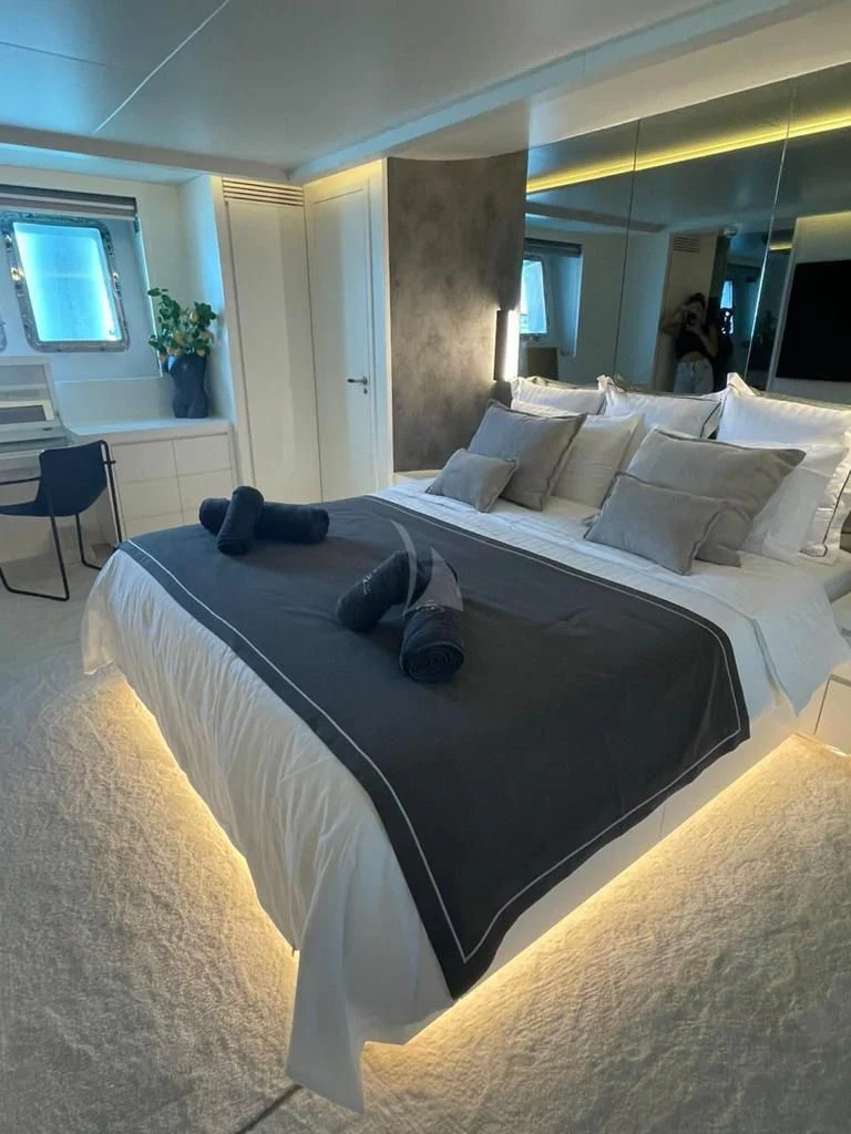 a bedroom with a large bed aboard EVA Yacht for Charter