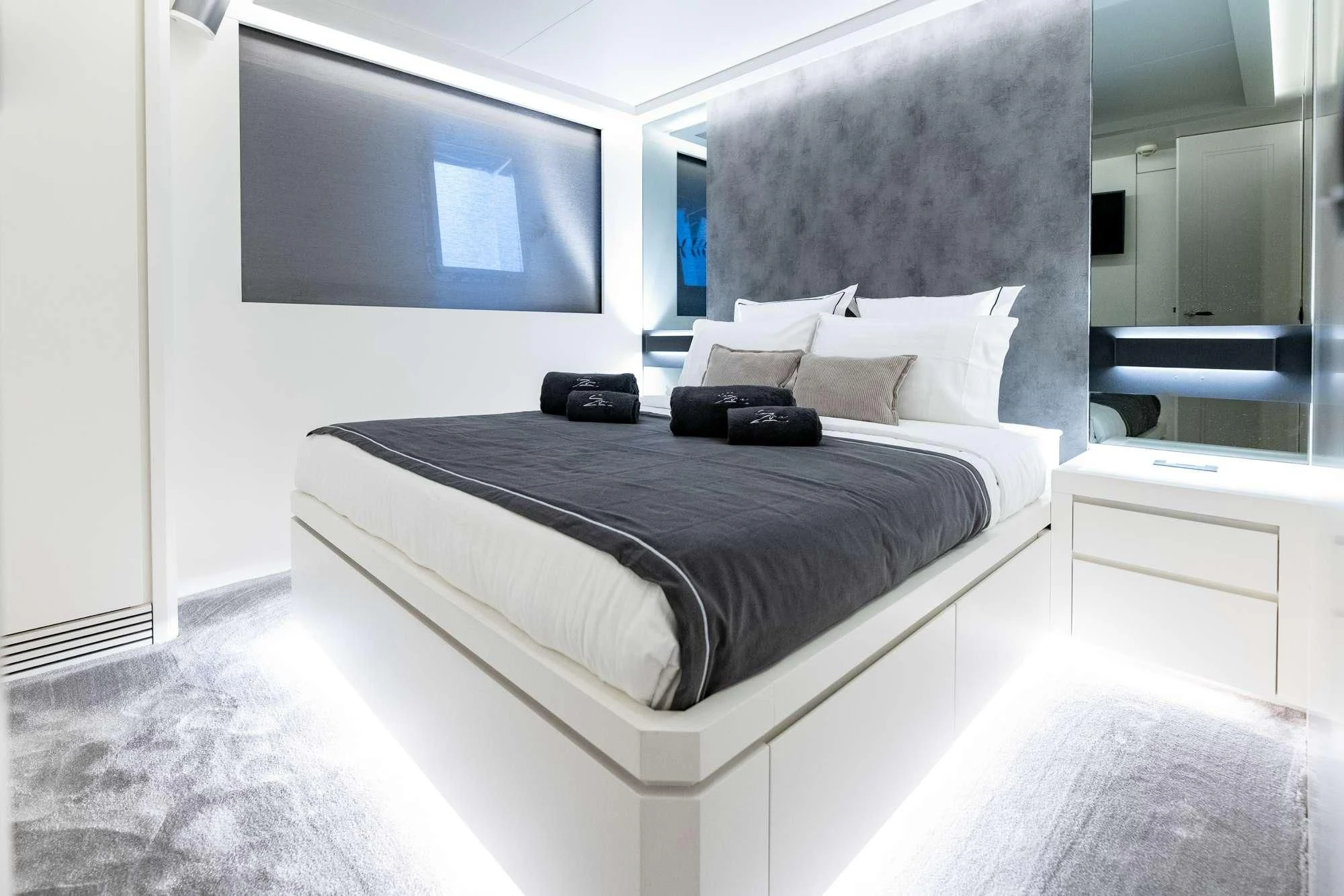 a bed with a black pillow aboard EVA Yacht for Charter