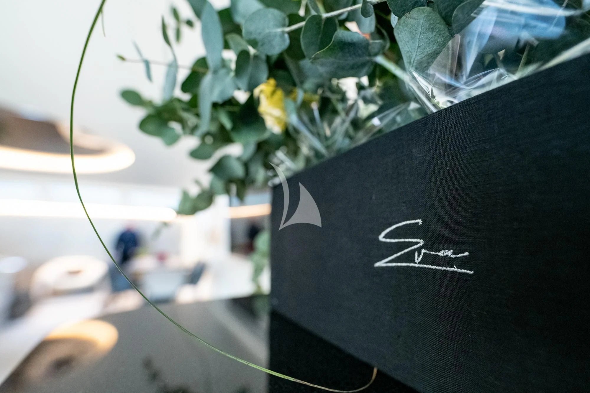 a black umbrella with a yellow flower aboard EVA Yacht for Charter