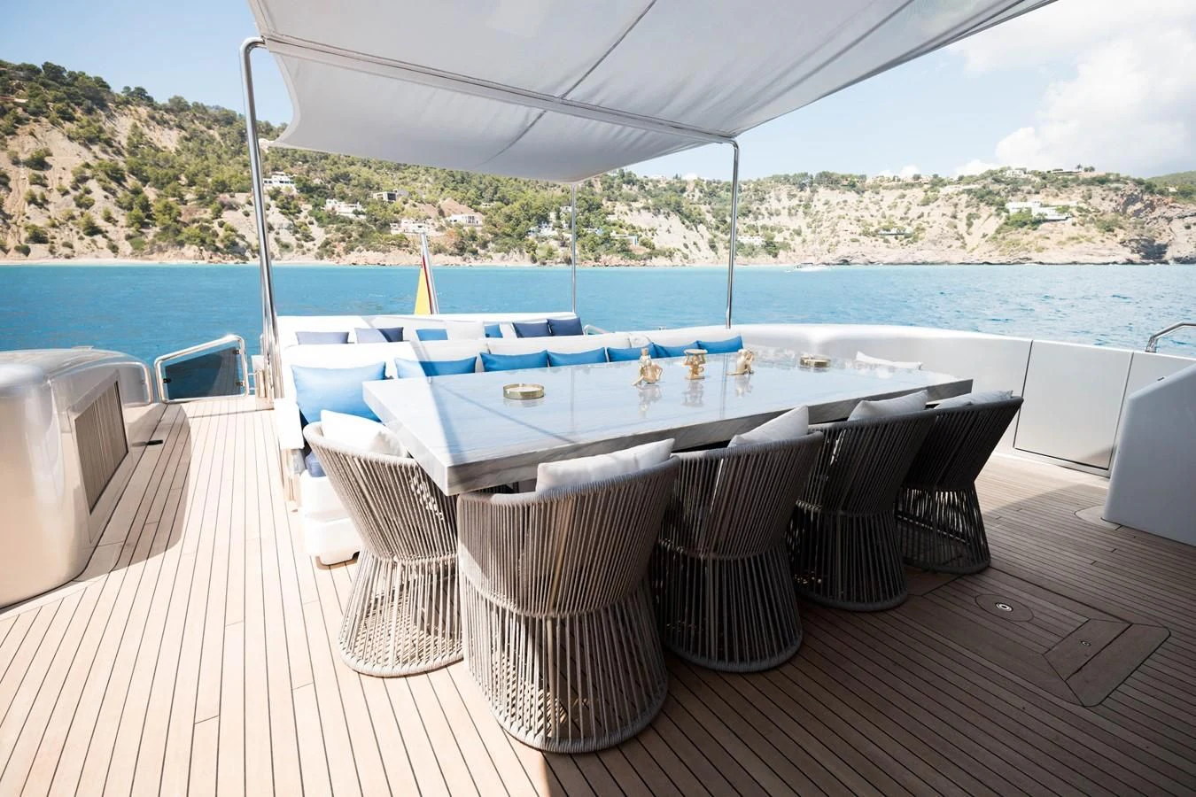 a table set up on a deck overlooking a large body of water aboard EVA Yacht for Charter
