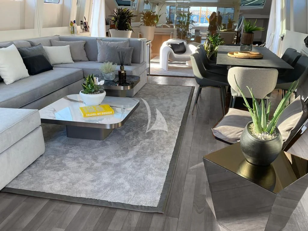 a living room with a couch and a table aboard EVA Yacht for Charter