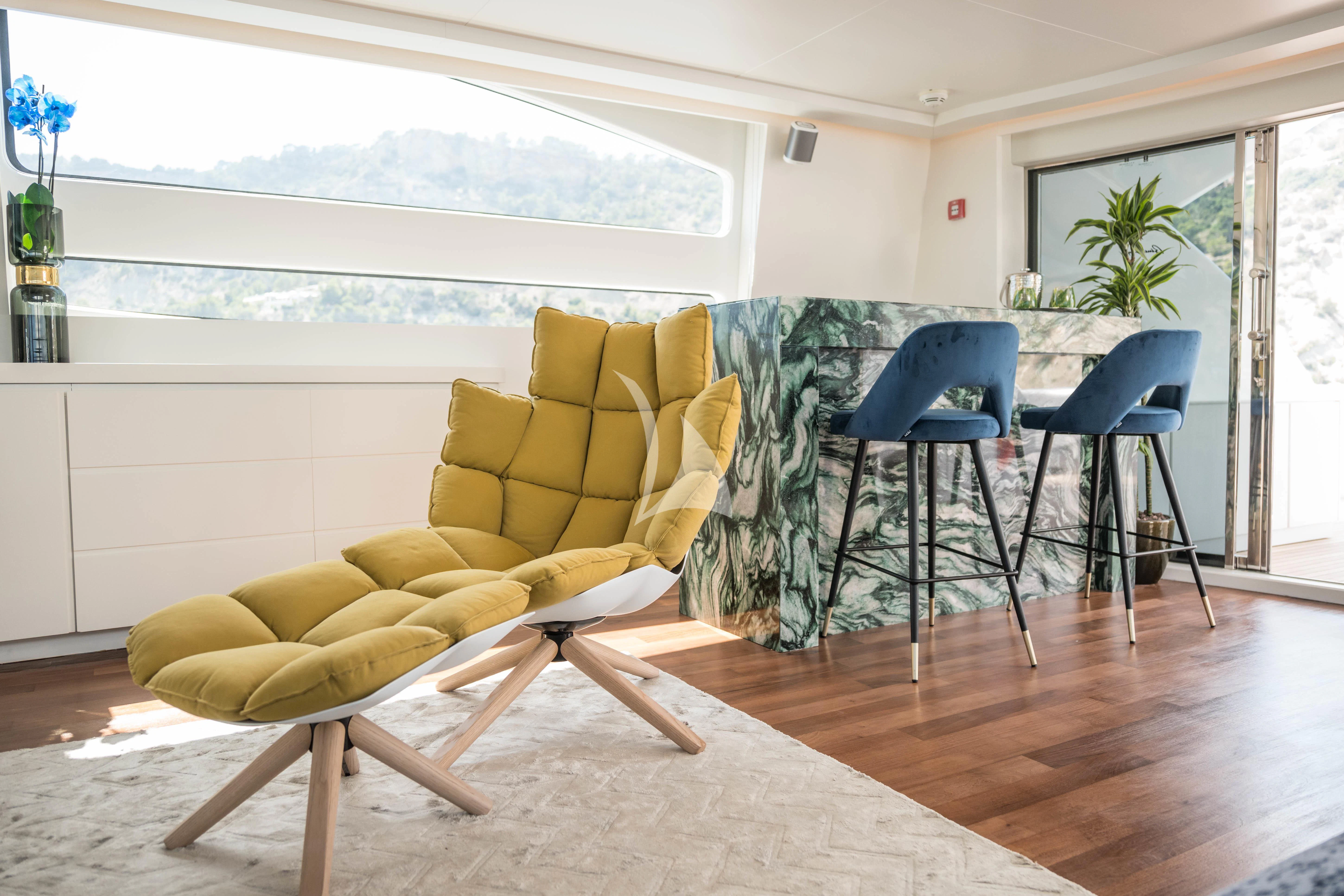 a living room with a couch and chairs aboard EVA Yacht for Charter