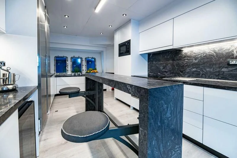 a kitchen with a large island aboard EVA Yacht for Charter