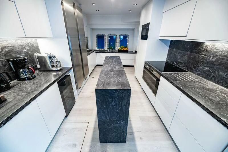 a kitchen with a marble counter top aboard EVA Yacht for Charter