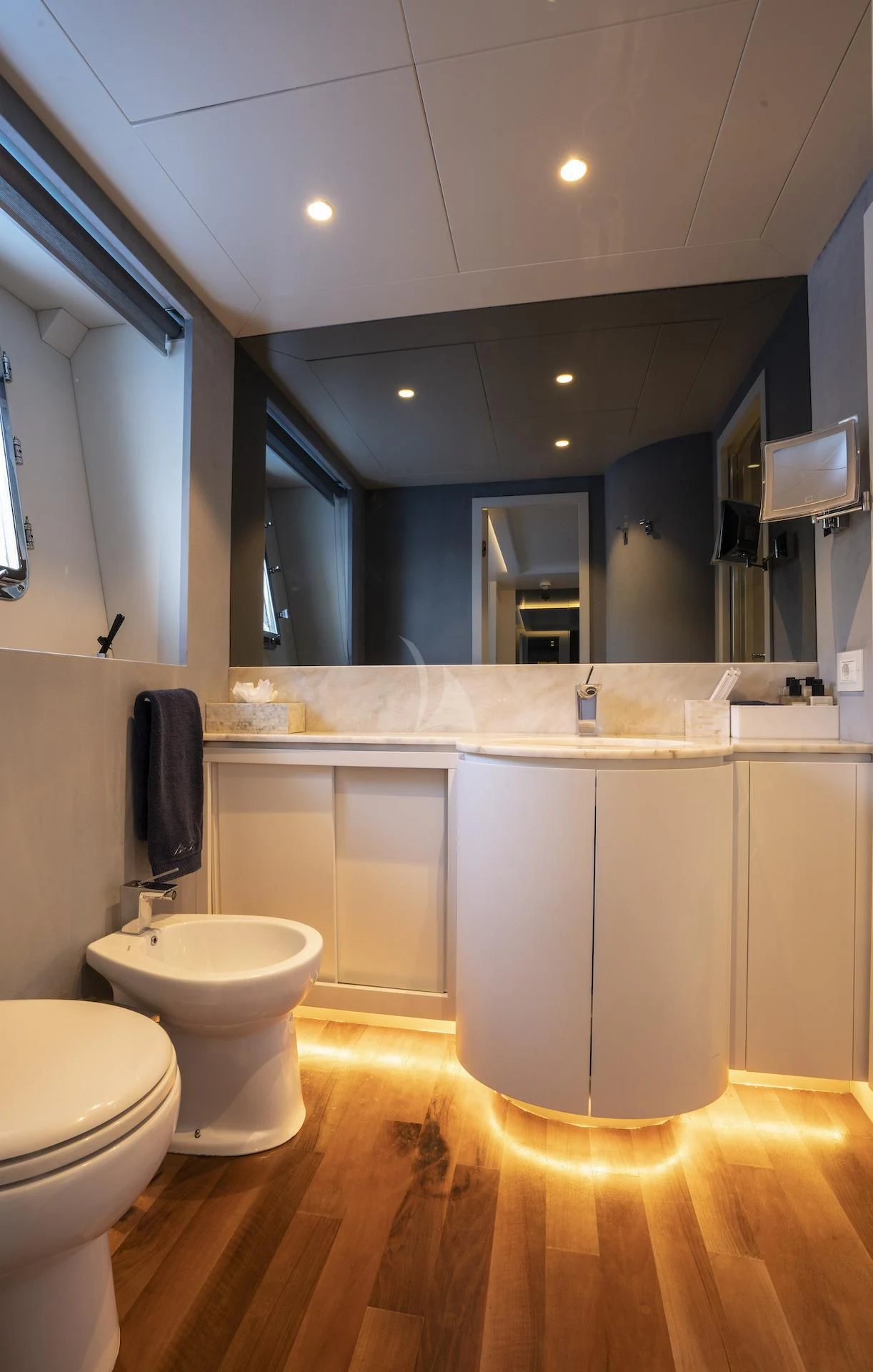 a bathroom with a large mirror aboard EVA Yacht for Charter