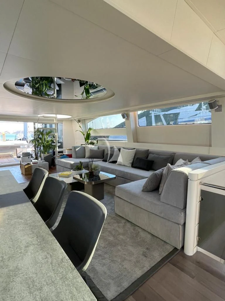 a living room with a large white sofa and a large white sofa aboard EVA Yacht for Charter