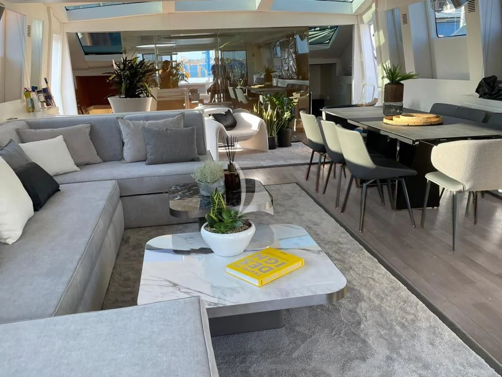 a living room with a table and couches aboard EVA Yacht for Charter