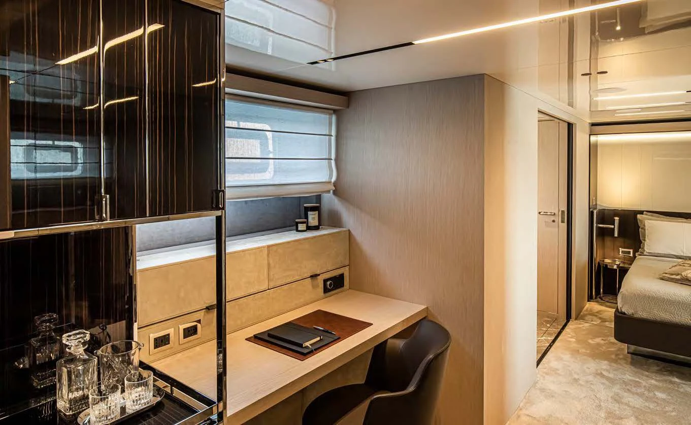 a room with a desk and a bed aboard SESSANTASETTE 67 Yacht for Sale