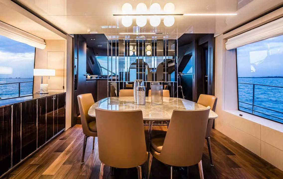 a room with a table and chairs aboard SESSANTASETTE 67 Yacht for Sale