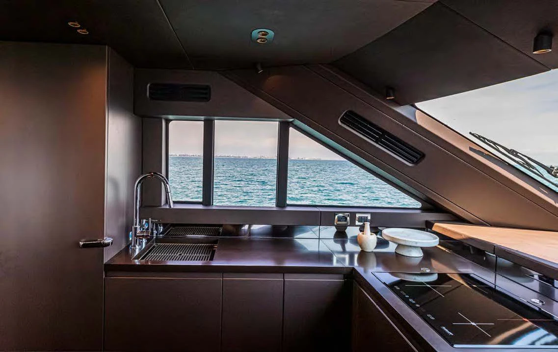 a kitchen with a large window aboard SESSANTASETTE 67 Yacht for Sale