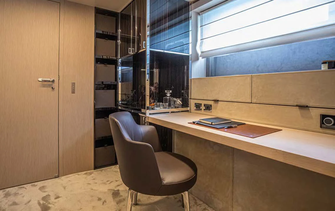 a chair next to a desk aboard SESSANTASETTE 67 Yacht for Sale