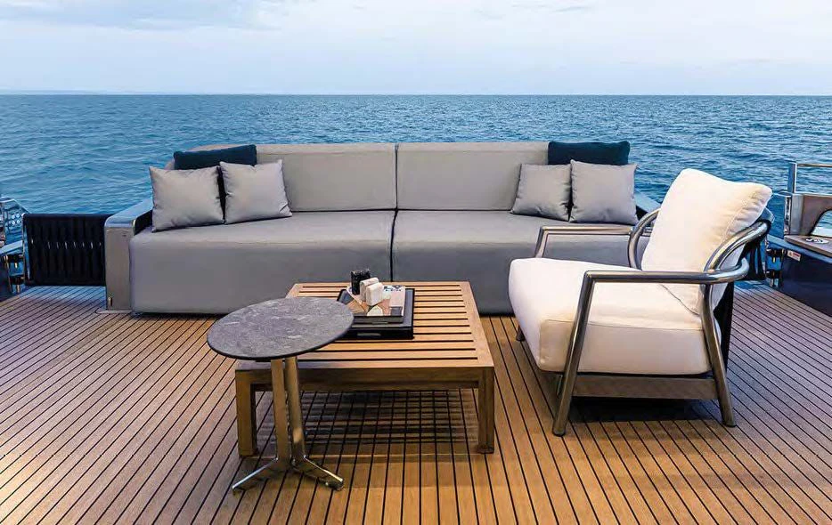 a couch and a table on a deck overlooking the ocean aboard SESSANTASETTE 67 Yacht for Sale