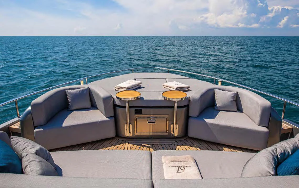 a living room with a couch and a table aboard SESSANTASETTE 67 Yacht for Sale