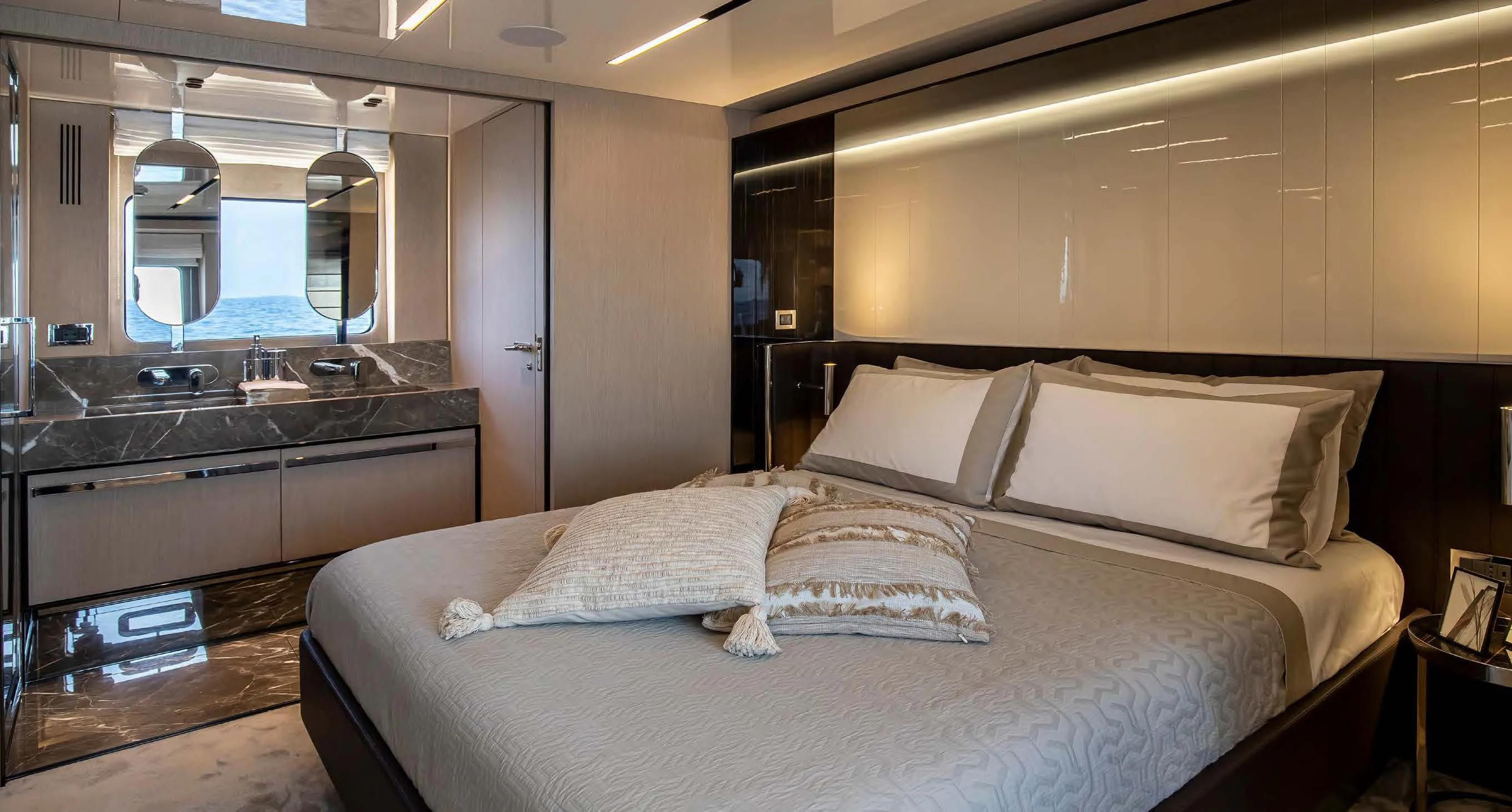 a bed with pillows on it aboard SESSANTASETTE 67 Yacht for Sale